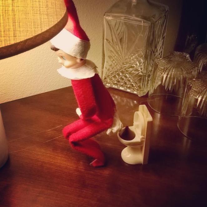 NOT FOR EVERYONE but a THRILL for my little potty humorists. Doll toilet, hersheys kiss. Used double sided tape to tape the elf's hat to the lampshade, holding him up. Also used double sided tape for the toilet paper.